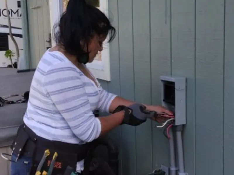 Licensed electrician wiring an exterior subpanel in Mayo