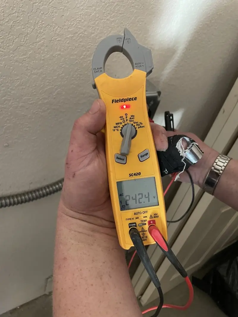 Voltage testing with clamp meter during Recessed Lighting Installation in Mayo
